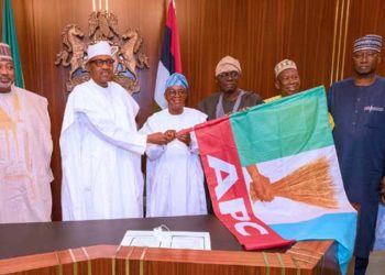 Osun Guber: Buhari Presents APC Flag To Oyetola