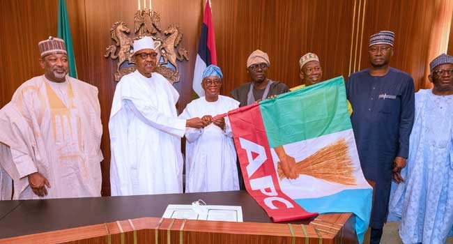 Osun Guber: Buhari Presents APC Flag To Oyetola 1 Buhari Oyetola