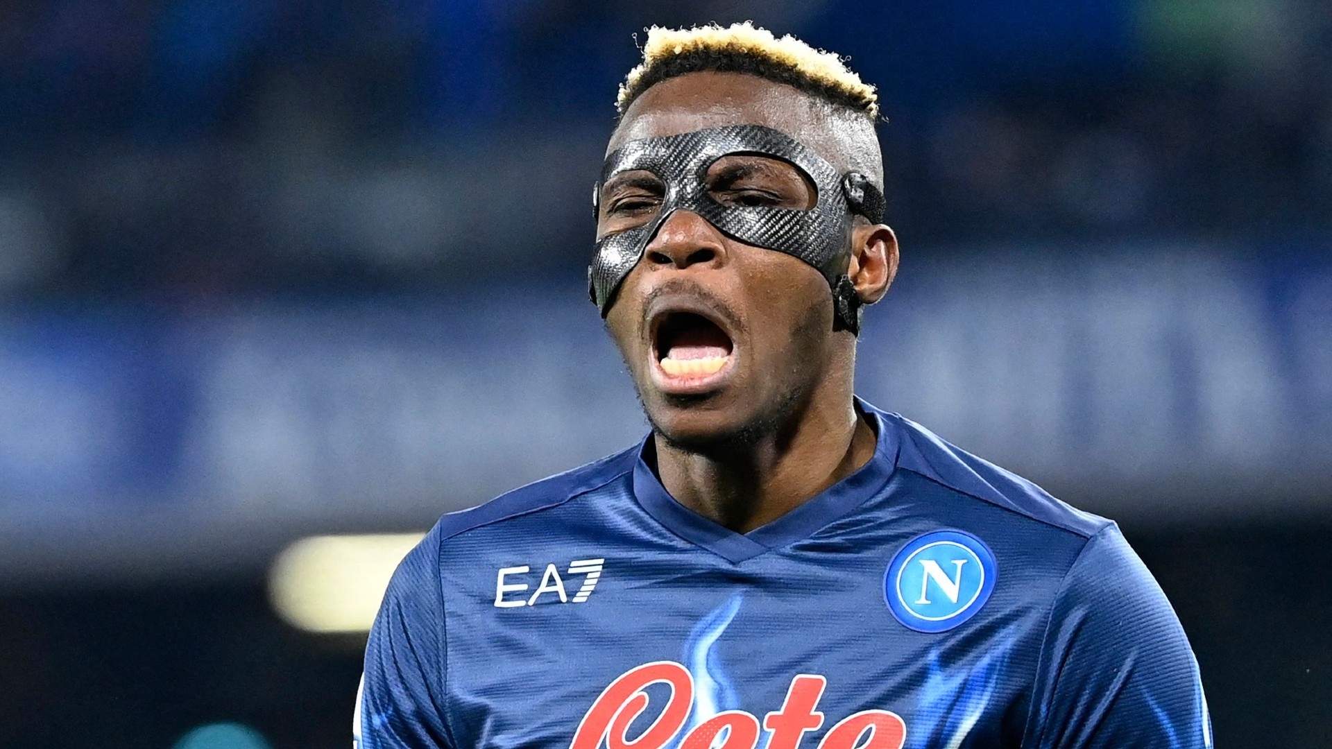  A photo of Victor Osimhen playing for Napoli, wearing a black mask to protect his face.