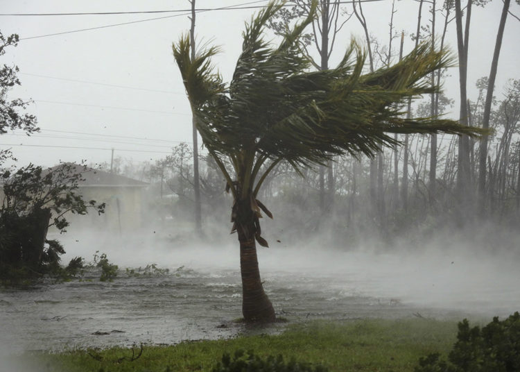 CORRECTS FROM CANAL TO ROAD - A road is flooded during the passing of Hurricane Dorian in Freeport, Grand Bahama, Bahamas, Monday, Sept. 2, 2019. Hurricane Dorian hovered over the Bahamas on Monday, pummeling the islands with a fearsome Category 4 assault that forced even rescue crews to take shelter until the onslaught passes. (AP Photo/Tim Aylen)