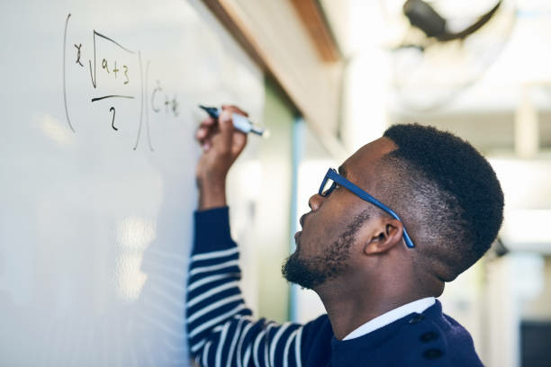 95% Of African Teachers Affirm Tech In Teaching Environment – Report 1 Cropped shot of a young man writing on a whiteboard in a classroom