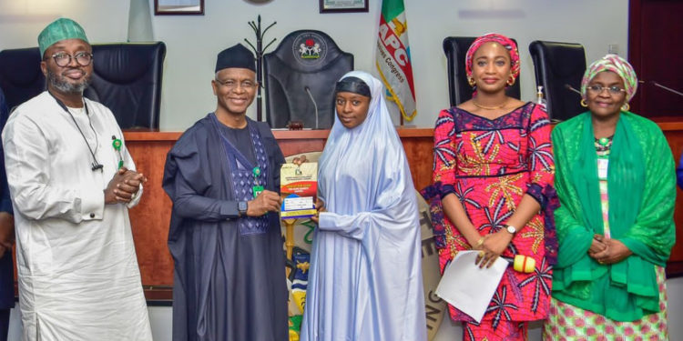 Governor Nasir El-Rufai handing over ownership documents to one of the traders who bought shops at Sheikh Abubakar Gumi market, along with Commissioner of Business, Innovation and Technology, Prof Kabir Mato (left), Hajiya Hafsat Mohammed Baba, Commissioner of Human Services and Social Development (right) as well as Managing Director of Kaduna Market Development and Management Company (KMDMC) Tamar Nandul at the ceremony.