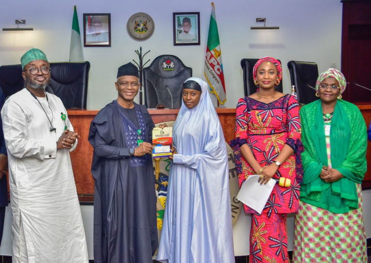 Governor Nasir El-Rufai handing over ownership documents to one of the traders who bought shops at Sheikh Abubakar Gumi market, along with Commissioner of Business, Innovation and Technology, Prof Kabir Mato (left), Hajiya Hafsat Mohammed Baba, Commissioner of Human Services and Social Development (right) as well as Managing Director of Kaduna Market Development and Management Company (KMDMC) Tamar Nandul at the ceremony.