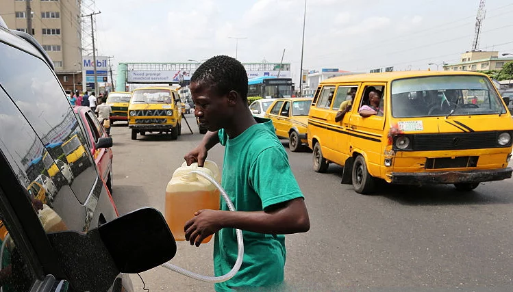 Black Market Thrives In Yobe, As Fuel Sells For N600 Per Litre 1 A man fills an automobile with fuel sold on the black market as others queue to buy fuel on a major road in Lagos, Nigeria, on Thursday, April 7, 2016. International energy companies in Nigeria have agreed to provide about $200 million to help fund fuel imports amid a foreign-currency shortage, which has caused widespread supply shortages Petroleum Minister of State Emmanuel Kachikwu said. Photographer: George Osodi/Bloomberg