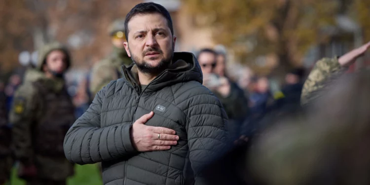 This handout photograph taken and released by Ukrainian Presidential press service on November 14, 2022, shows Ukrainian President Volodymyr Zelensky taking part in the flag laying ceremony during his visit to the newly liberated city of Kherson, following the retreat of Russian forces from the strategic hub. (Photo by Handout / UKRAINIAN PRESIDENTIAL PRESS SERVICE / AFP) / RESTRICTED TO EDITORIAL USE - MANDATORY CREDIT "AFP PHOTO / HO - UKRAINIAN PRESIDENTIAL PRESS SERVICE" - NO MARKETING NO ADVERTISING CAMPAIGNS - DISTRIBUTED AS A SERVICE TO CLIENTS - RESTRICTED TO EDITORIAL USE - MANDATORY CREDIT "AFP PHOTO / HO - UKRAINIAN PRESIDENTIAL PRESS SERVICE" - NO MARKETING NO ADVERTISING CAMPAIGNS - DISTRIBUTED AS A SERVICE TO CLIENTS /