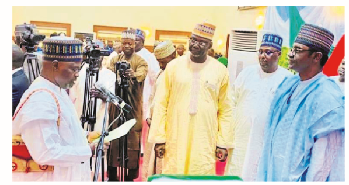 Gov Buni Swears-in New HoS, 17 LG Caretaker C’ttee Chairmen 1 Yobe State Governor Mai Mala Buni (right) during the swearing-in of new head of service, Garba Bilal in Damaturu