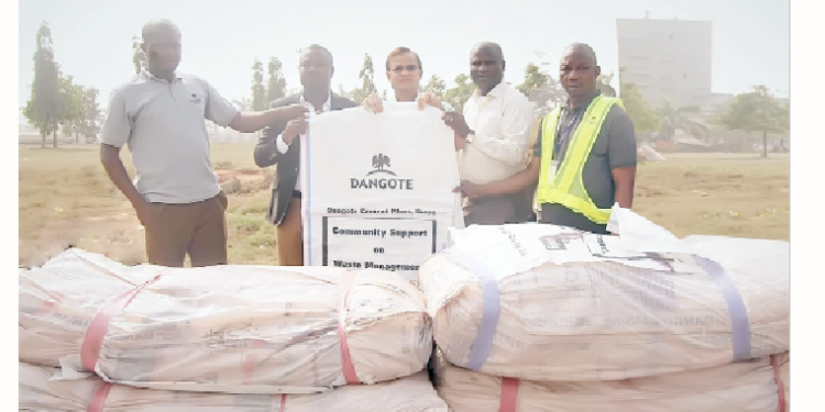 Plant director, Dangote Cement Ibese Plant, Azad Nawabuddin (middle) presents the bags to the CEO, Niels Deck Nig. Limited, Daniel Akpan (second left) with the participation of the technical assistant to the plant director and head, Alternative Fuel, Ibese, Sumaila Rasheed (left);  head, social performance,  Ademola Ojolowo (second right) and the acting head, Stores, Musa Salisu.