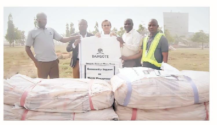 Plant director, Dangote Cement Ibese Plant, Azad Nawabuddin (middle) presents the bags to the CEO, Niels Deck Nig. Limited, Daniel Akpan (second left) with the participation of the technical assistant to the plant director and head, Alternative Fuel, Ibese, Sumaila Rasheed (left);  head, social performance,  Ademola Ojolowo (second right) and the acting head, Stores, Musa Salisu.