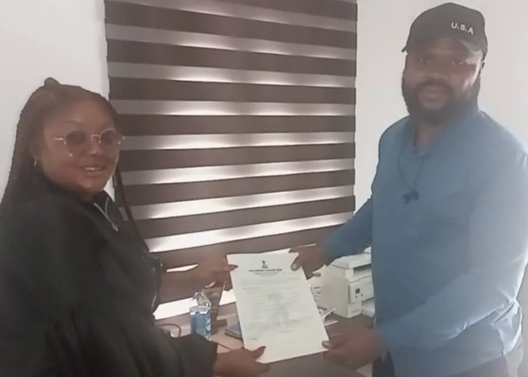 L-R: DG, Cross River State Scholarship Board, Nuella Tessy, handing over scholarship forms to Mr. Philip Obim, in Calabar.