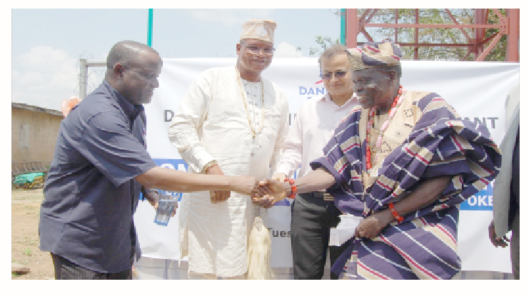 Dangote Cement: Training Youth In Host Community For Self-reliance 1 General manager, Human Assets Managemnet/Admin, Abu Sufyan (left) exchanging pleasantries with the Baale of Abule Oke, Chief Ramon Akinsanya at the commissioning and handover of a solar-powered borehole donated by Dangote Cement to Abule Oke community to the admiration of Oba Lukmon Kuoye, Olu of Imasayi (2nd left) and plant director, Dangote Cement Plant Ibese, Azad Nawabuddin (2nd right).