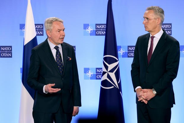 Finnish Foreign Minister Pekka Haavisto (left) hands over his nation's accession document to US Secretary of State, Antony Blinken, as NATO Secretary-General Jens Stoltenberg (centre) oversees a joining ceremony at NATO headquarters in Brussels, Belgium on Tuesday. 

Credit: Johanna Geron/Pool/Reuters]