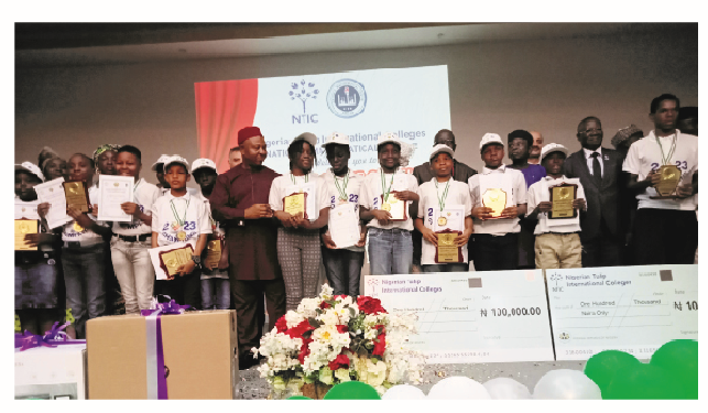 Students displaying their awards at 20th NTIC national mathematics competition in Abuja.