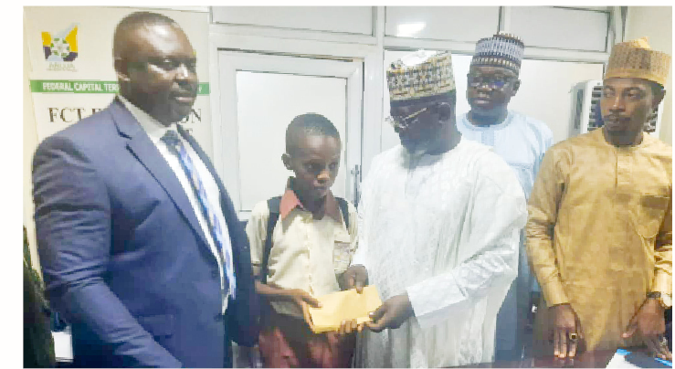 FCT School Sports Festival: Excitement As RSDF Splashes Cash On Winners 1 Secretary, FCT Education Secretariat, Sani Dahiru EL-Katuzu (3rd right) presenting cash rewad to the one of the winners of FCT School Sports Festival while president, Ratels Sports Development Foundation (RSDF), Barr. Paul Edeh look on during the presentation of reward at the FCTA secretariat, yesterday.