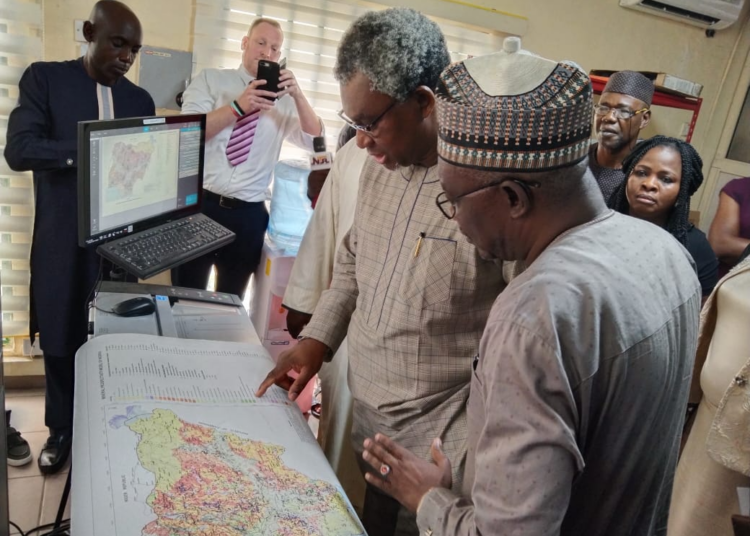 Minister of Mines and Steel Development, Arc Olamilekan Adegbite, inspecting facilities at the National Geodata Centre, Abuja. He is assisted by the director -general of Nigeria Geologial Survey Agency, Abdulrazak Garba