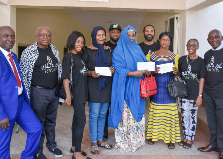 L-R: Assistant Director of Radiotherapy, National Hospital, Abuja, Dr. Patrick Ida (left); Vice Chairman, WHHF,  Egnr. Titus Omolewa (2nd left); WHHF Programmes Manager, Joy Okoye (3rd left); WHHF Board members, Victor Okoye (5th left); Emma Okoye (4th right); Pauline Okoye (2nd right) and Barr. Patrick Abah, WHHF Legal Adviser (right); alongside the recipients of the money grant for cancer patients on the occasion of the 4th memorial anniversary of Late Evang. Helen Titilayo Okoye at the National Hospital, Abuja on Tuesday.

Credit: NAN