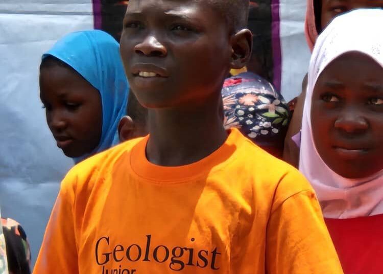 A student of Malami Academy, Master Ali Adamu Faruq, who was inducted into the Junior Geologists Club,  poses with his peers during the ceremony, in Nasarawa, Nasarawa State