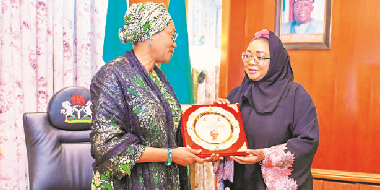 L-R: First Lady, Senator Oluremi Tinubu CON (left) receiving a plaque from the minister of state for Police Affairs, Imaan Suleiman-Ibrahim while on a courtesy visit to her office at the State House, Abuja yesterday.