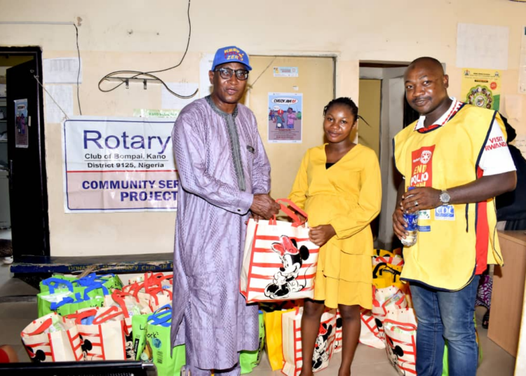 L-R)
Rotarian Arc Sagab  Sani DG District 9125, one of the beneficiaries (Middle), and 
Rotarian Onimisi Hamza Ohere, President, Rotary Club of Bompai, at the distribution of maternal, child health items in Sabon-Gari Kano