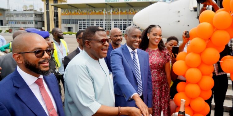 Governor Bassey Otu, 2nd left, and CEO, Aero Contractors, Captain Ado Sanusi, cutting the inauguration cake.