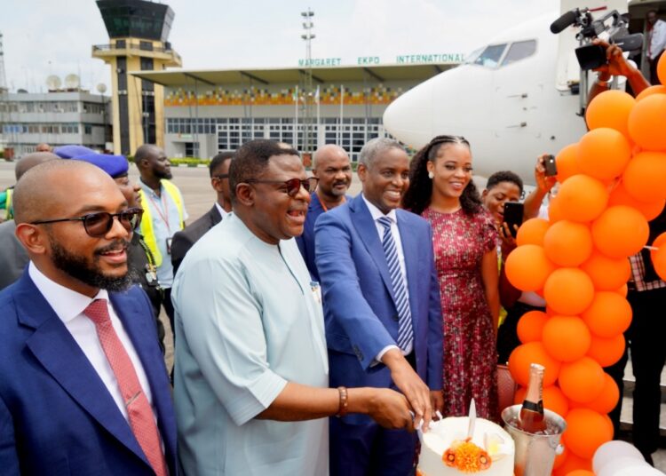 Governor Bassey Otu, 2nd left, and CEO, Aero Contractors, Captain Ado Sanusi, cutting the inauguration cake.