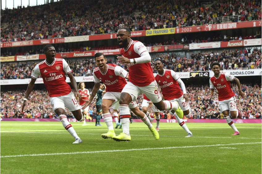 Soccer-Arsenal move top of the league with 2-0 win over Brighton