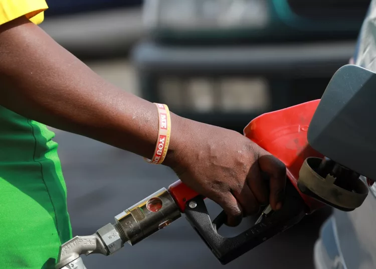 A gas station attendant pumps fuel into a customer's car at the NNPC Mega petrol station in Abuja, Nigeria March 19, 2020. REUTERS/Afolabi Sotunde