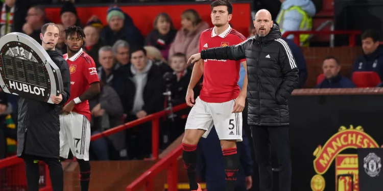 MANCHESTER, ENGLAND - DECEMBER 27: Harry Maguire of Manchester United prepares to enter the pitch as a substitute as Erik ten Hag, Manager of Manchester United looks on during the Premier League match between Manchester United and Nottingham Forest at Old Trafford on December 27, 2022 in Manchester, England. (Photo by Stu Forster/Getty Images)