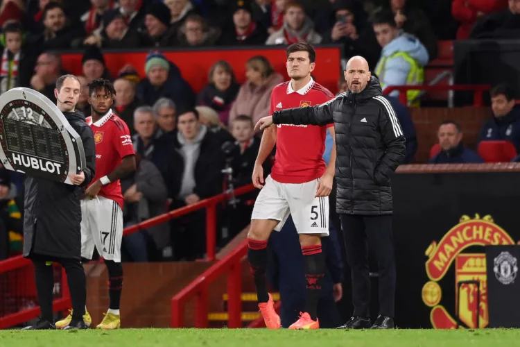 MANCHESTER, ENGLAND - DECEMBER 27: Harry Maguire of Manchester United prepares to enter the pitch as a substitute as Erik ten Hag, Manager of Manchester United looks on during the Premier League match between Manchester United and Nottingham Forest at Old Trafford on December 27, 2022 in Manchester, England. (Photo by Stu Forster/Getty Images)