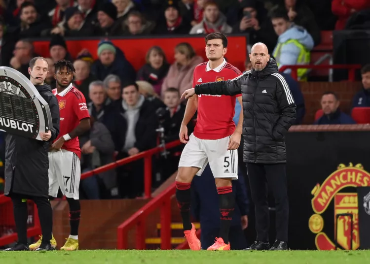 MANCHESTER, ENGLAND - DECEMBER 27: Harry Maguire of Manchester United prepares to enter the pitch as a substitute as Erik ten Hag, Manager of Manchester United looks on during the Premier League match between Manchester United and Nottingham Forest at Old Trafford on December 27, 2022 in Manchester, England. (Photo by Stu Forster/Getty Images)