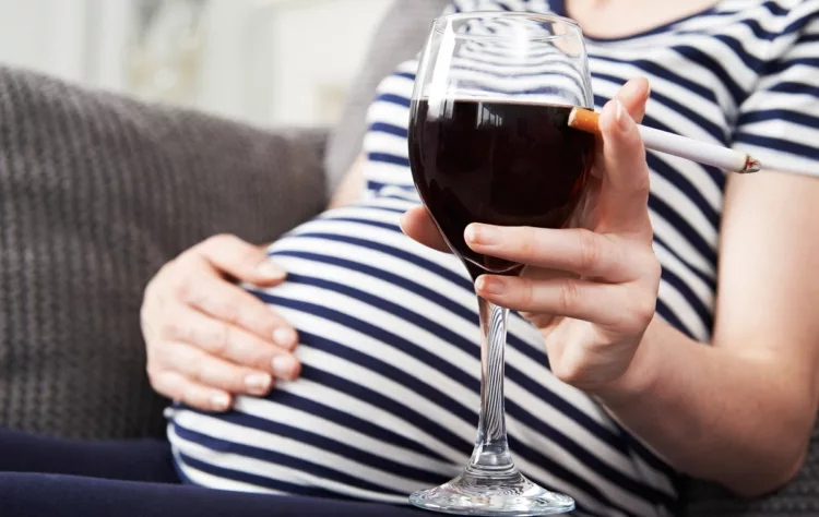 Close Up Of Pregnant Woman Smoking And Drinking