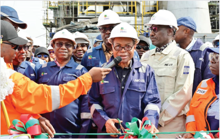 PROMISE KEPT: Chairman, NNPC Board, Chief Pius Akinyelure, cuts a tape to mark the official announcement of the mechanical completion and flare start-up of Area 5 Plant of the Refinery. Standing from right is the GCEO, NNPC Ltd, Mr. Mele Kyari and behind the Board Chairman is the Minister of State for Petroleum Resources (Oil), Senator Heineken Lokpobiri.