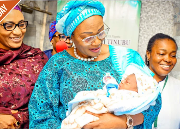 First Lady, Senator Oluremi Tinubu (middle), welcoming the first baby of the Year 2024, Boluwatife Johnson who was born at 12.03am at the National Hospital Abuja, yesterday. While vice president's wife, Nana Shettima (left), watches on