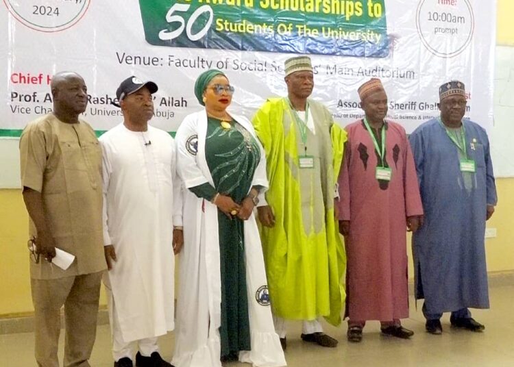 Founder, Hajia Hadiza Vatsa foundation, Amb. Hajiya Hadiza Mamman Vasta (3rd L); Vice Chancellor, University of Abuja Prof. Abdul-Rasheed Na'Allah(3rdR) and other stakeholders, during, an Award of Scholarship to 50 students at the University in Abuja on Saturday