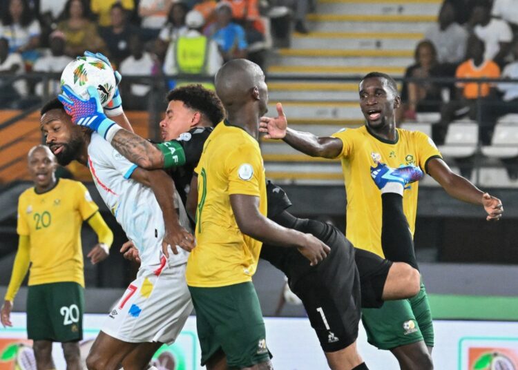 South Africa's goalkeeper #1 Ronwen Williams makes a save during the Africa Cup of Nations (CAN) 2024 third place play-off football match between South Africa and Democratic Republic of Congo at Felix Houphouet-Boigny Stadium in Abidjan on February 10, 2024. (Photo by Sia KAMBOU / AFP)