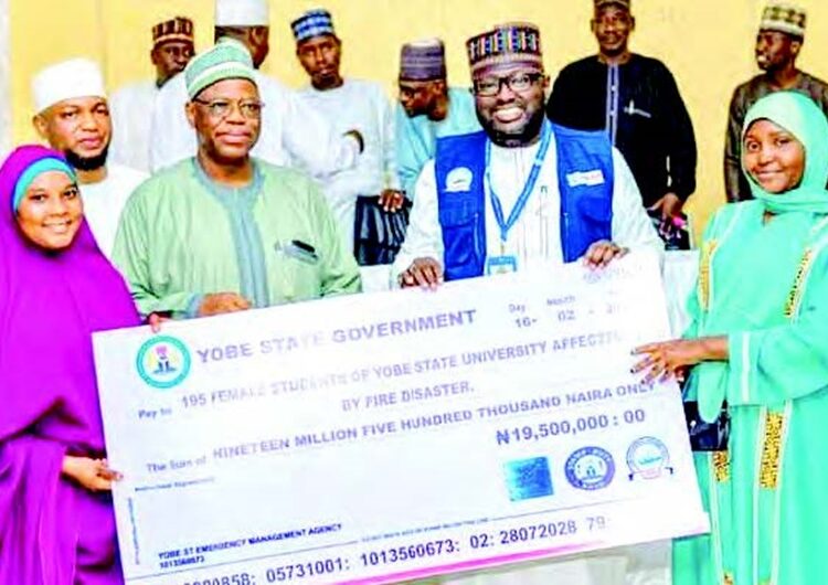 VC Yobe State University, Prof. Mala Daura (2nd left) and the SEMA State director, Rescue, Dr Baba Jalo presenting cash support
to the inferno victims