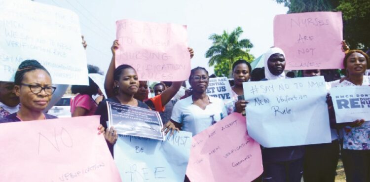 National Association of Nigeria Nurses and Midwives (NANNW), Abuja chapter, protesting against the new verification guidelines, in Abuja yesterday. PHOTO BY IBRAHIM MOHAMMED