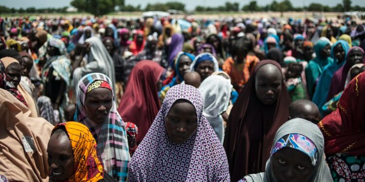In this photo taken on September 15, 2016 women and children queue to enter one of the Unicef nutrition clinics at the Muna makeshift camp which houses more than 16,000 IDPs (internaly displaced people) on the outskirts of Maiduguri, Borno State, northeastern Nigeria.
Aid agencies have long warned about the risk of food shortages in northeast Nigeria because of the conflict, which has killed at least 20,000 since 2009 and left more than 2.6 million homeless. In July, the United Nations said nearly 250,000 children under five could suffer from severe acute malnutrition this year in Borno state alone and one in five -- some 50,000 -- could die.  / AFP PHOTO / STEFAN HEUNIS
