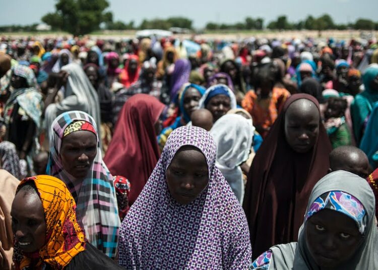 In this photo taken on September 15, 2016 women and children queue to enter one of the Unicef nutrition clinics at the Muna makeshift camp which houses more than 16,000 IDPs (internaly displaced people) on the outskirts of Maiduguri, Borno State, northeastern Nigeria.
Aid agencies have long warned about the risk of food shortages in northeast Nigeria because of the conflict, which has killed at least 20,000 since 2009 and left more than 2.6 million homeless. In July, the United Nations said nearly 250,000 children under five could suffer from severe acute malnutrition this year in Borno state alone and one in five -- some 50,000 -- could die.  / AFP PHOTO / STEFAN HEUNIS