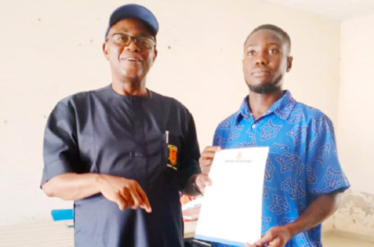 L-R: Proprietor, FOSLA Academy, Sani Abdullahi Lulu presenting employment letter to ex-student of the Institution, Dauda Jibrin as new store manager