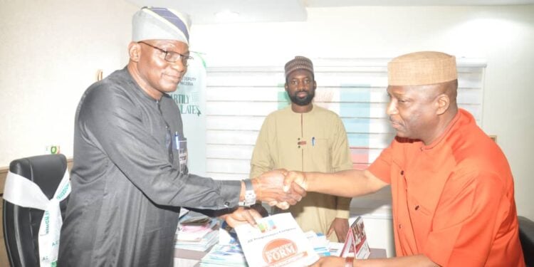 Dr. Ohunyeye (right) presenting his forms and credentials to party officials in Abuja