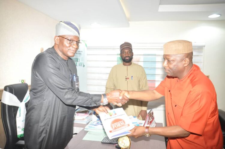 Dr. Ohunyeye (right) presenting his forms and credentials to party officials in Abuja