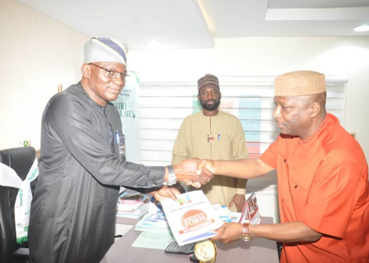 Dr. Ohunyeye (right) presenting his forms and credentials to party officials in Abuja