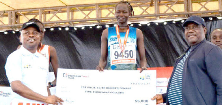 L-R: MD/CEO, PremiumTrust Bank, Emmanuel Efe Emefienim;  winner, Elite Runner (Female), Gaspore Atalena and SGF, George Akume at the PremiumTrust Bank Abuja City International Half Marathon event in Abuja recently.