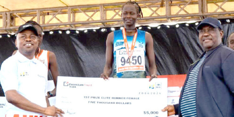 L-R: MD/CEO, PremiumTrust Bank, Emmanuel Efe Emefienim;  winner, Elite Runner (Female), Gaspore Atalena and SGF, George Akume at the PremiumTrust Bank Abuja City International Half Marathon event in Abuja recently.