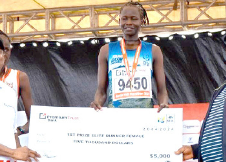 L-R: MD/CEO, PremiumTrust Bank, Emmanuel Efe Emefienim;  winner, Elite Runner (Female), Gaspore Atalena and SGF, George Akume at the PremiumTrust Bank Abuja City International Half Marathon event in Abuja recently.