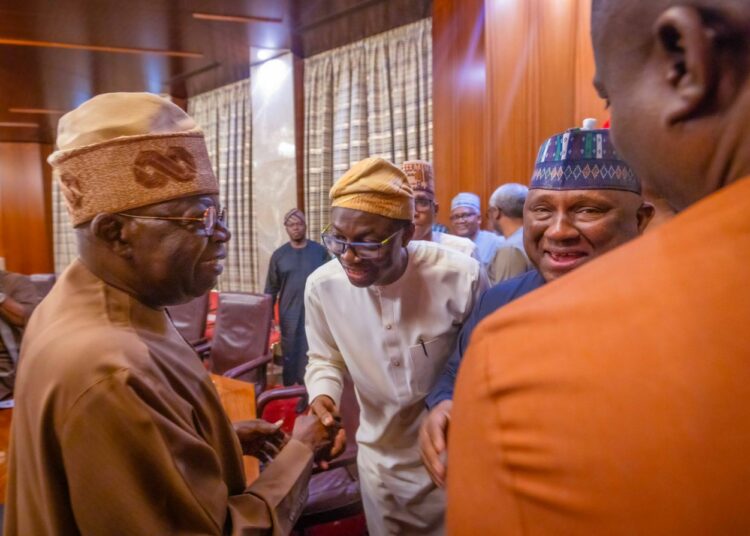 Abdulkabir Aliu (middle) exchanging pleasantries with President Bola Tinubu (left) during the inaugural meeting of the PEEC members.