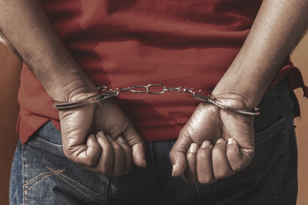 Anti-Drug Agency Smashes Cocaine Cartel In Lagos, Arrests 6 Suspects 1 man under arrest criminal scene 600nw 1108211540