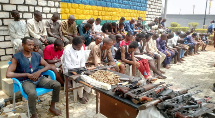 A cross section of suspected kidnappers, bandits and armed robbers, including the suspected mastermind of the March 28, 2022 Abuja-Kaduna train attack being paraded at the Kaduna State Police Command in Kaduna, yesterday PHOTO BY IBRAHIM MOHAMMED