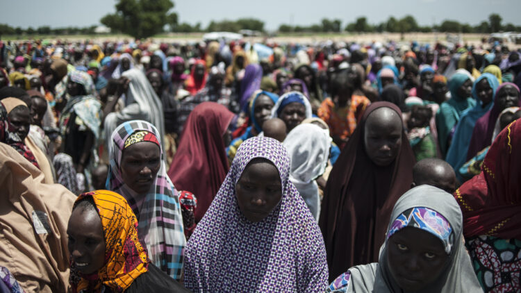 In this photo taken on September 15, 2016 women and children queue to enter one of the Unicef nutrition clinics at the Muna makeshift camp which houses more than 16,000 IDPs (internaly displaced people) on the outskirts of Maiduguri, Borno State, northeastern Nigeria.
Aid agencies have long warned about the risk of food shortages in northeast Nigeria because of the conflict, which has killed at least 20,000 since 2009 and left more than 2.6 million homeless. In July, the United Nations said nearly 250,000 children under five could suffer from severe acute malnutrition this year in Borno state alone and one in five -- some 50,000 -- could die.  / AFP PHOTO / STEFAN HEUNIS