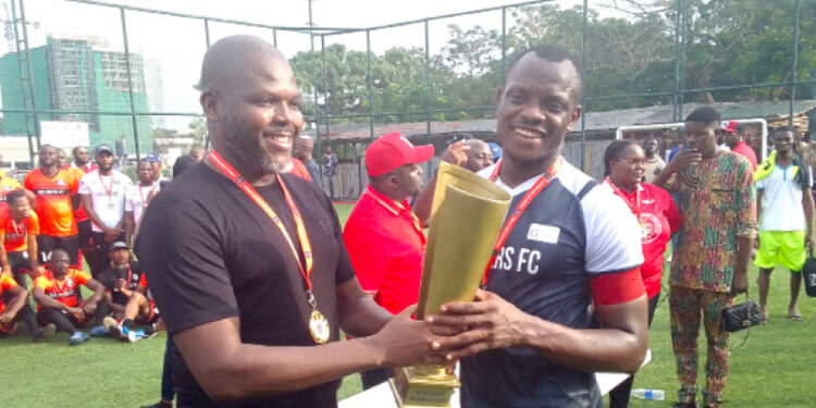 Former chairman of NBA, Lagos branch, Chukwuka Ikwuazom (SAN) presents to the captain Glaciers FC, winner of the 2024 Abuja Lawyers League